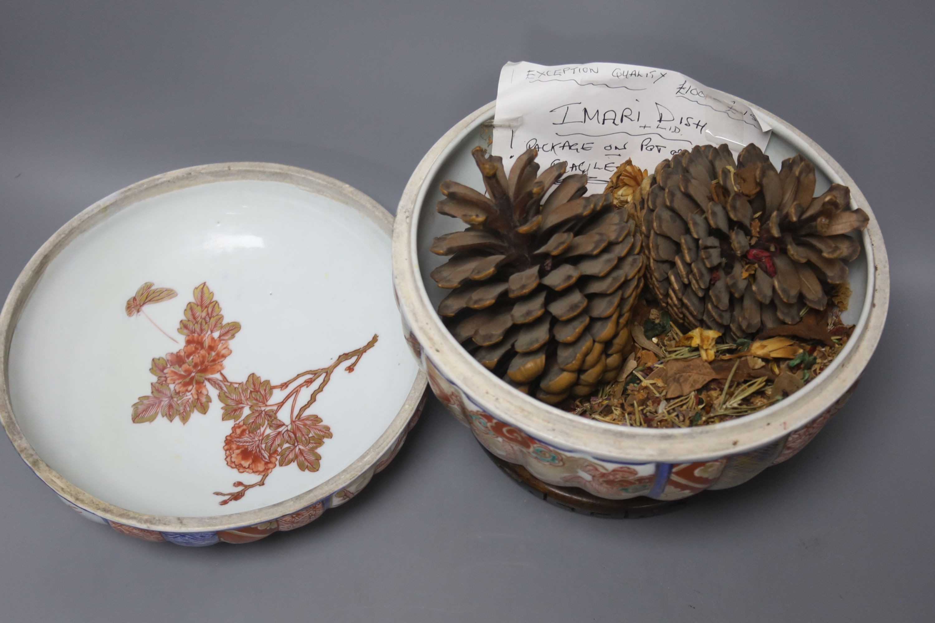 A 19th century Japanese Imari box and cover and a Satsuma pottery figure of a boy holding a Daruma doll, tallest 20cm